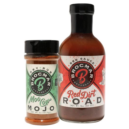 A bottle of red dirt road sauce next to a jar.