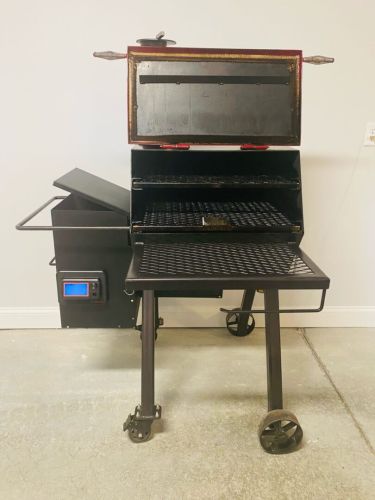 A grill sitting on top of a metal cart.