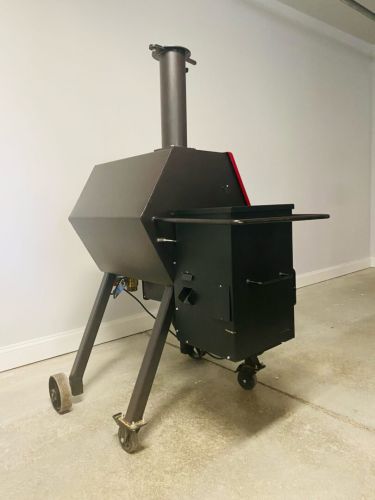 A black and red grill sitting on top of a floor.