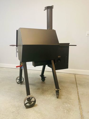 A black grill sitting on top of a floor.