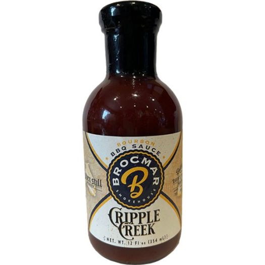 A bottle of bbq sauce with the name " boccam cripple creek ".